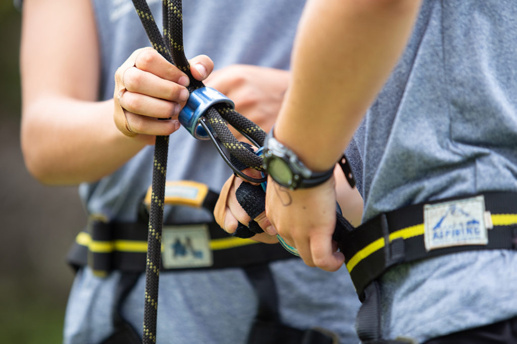Preparing the harness to climb the high ropes.